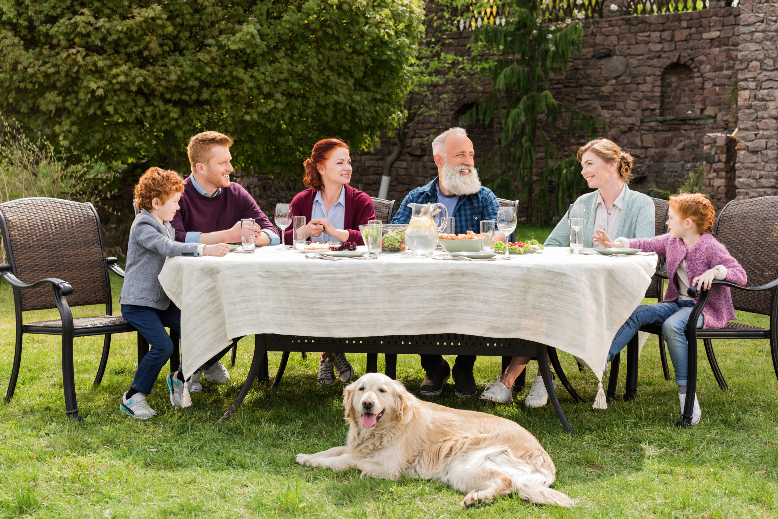 big happy family having dinner together at countryside